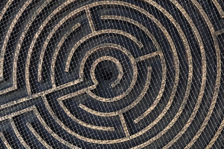 Circular labyrinth design with tiled mosaic pattern.