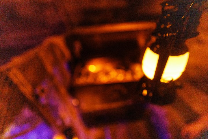 Blurred image of a glowing lantern near a treasure chest.