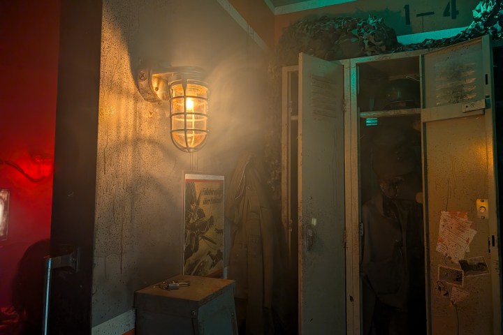 Dimly lit hallway with vintage lockers, wall light, and a hanging coat.